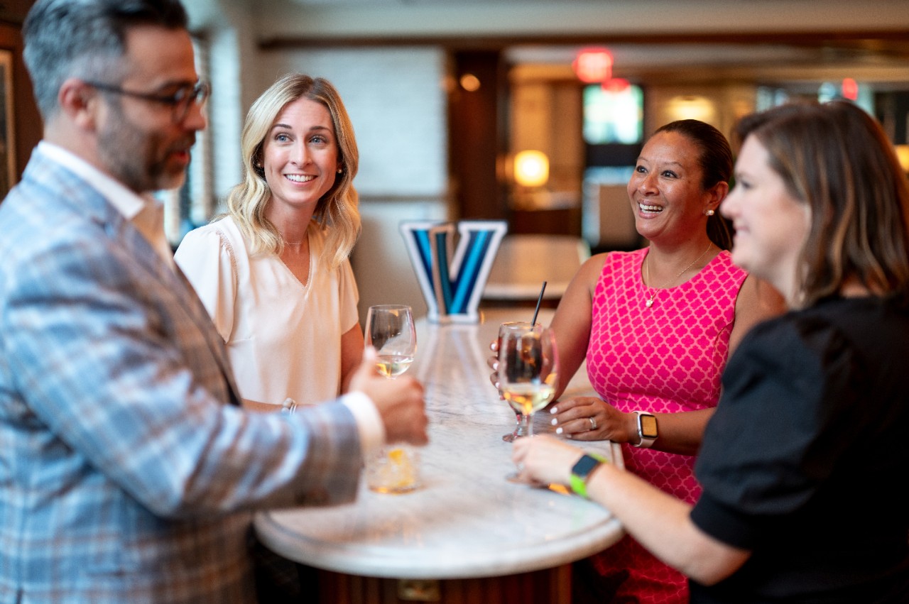 Alumni talking around a table