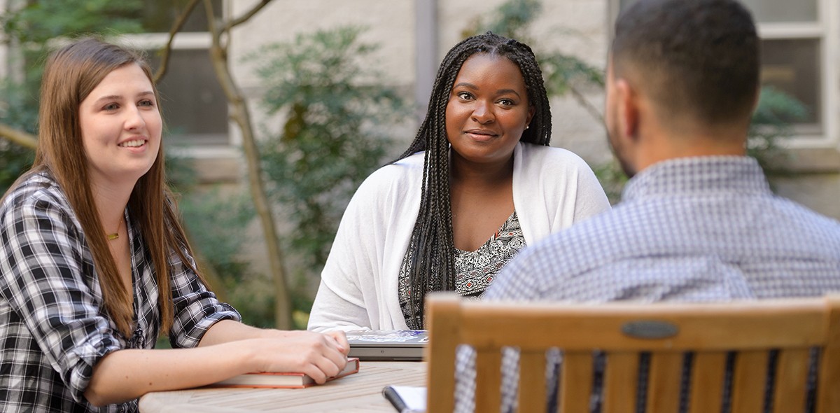 Graduate students talking outside on the Villanova campus