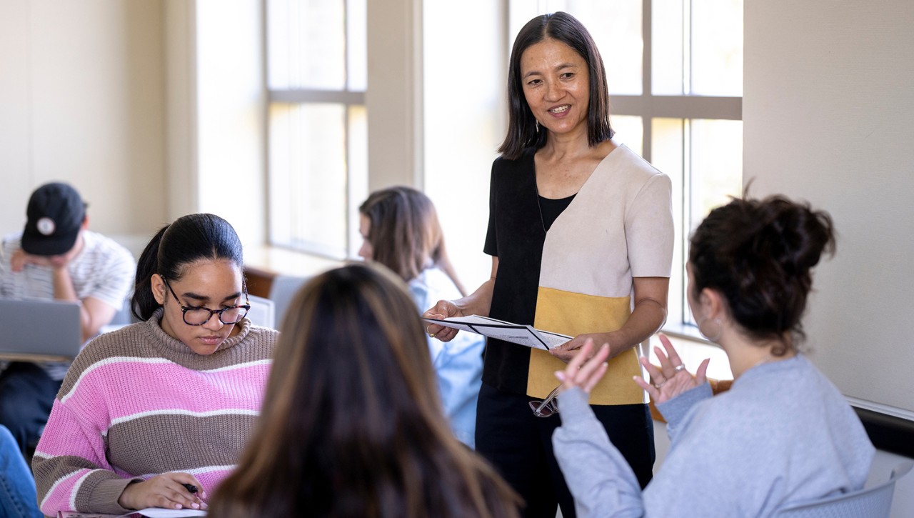 Professor standing and interacting with students in class