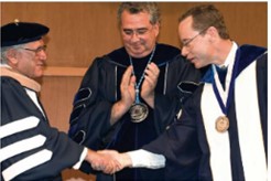 Richard shaking hand with a student