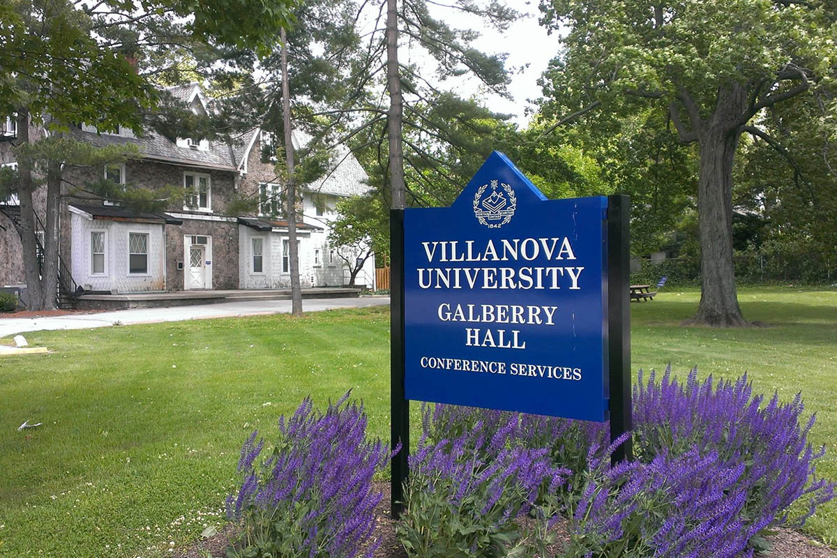 Galberry Hall sign on campus surrounded by flowers