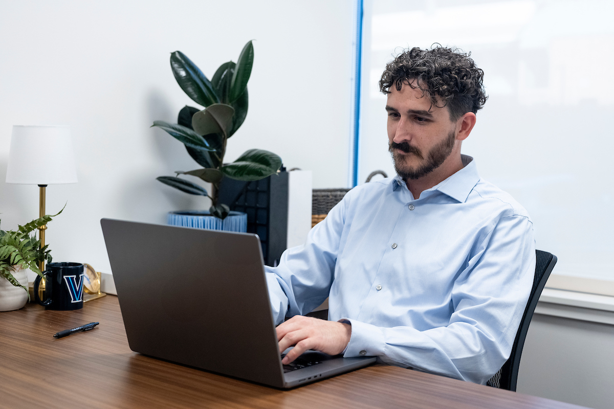 man working on a laptop in an office